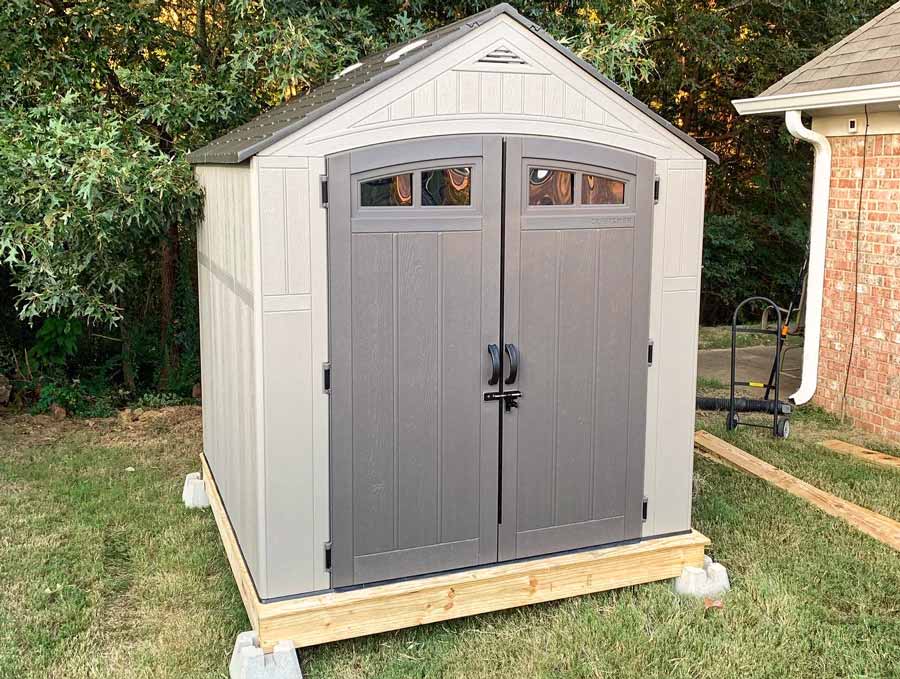 front-of-assembled-storage-shed-from-home-improvement-store-on-custom-built-deck-frame-for-7x7-foot-outdoor-structure-desoto-county-mississippi