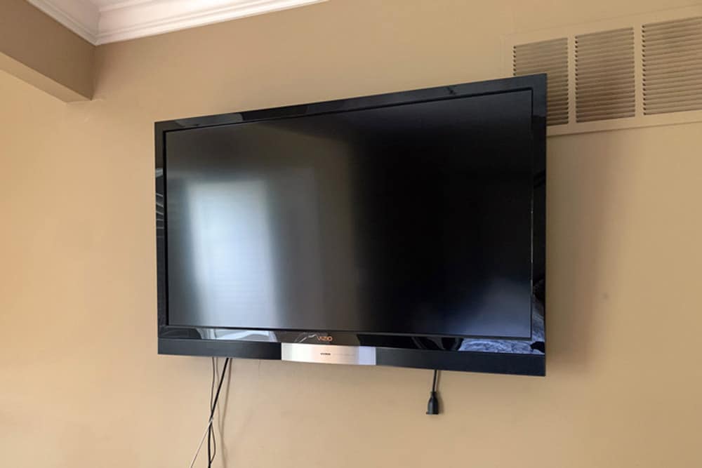 mounted tv pro service complete on bare wall in master bedroom by handyman in desoto county mississippi