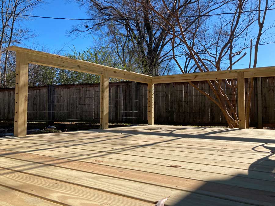 deckboard view of finished custom deck and rail construction project near university of memphis campus public outdoor seating style cables and look at blue sky