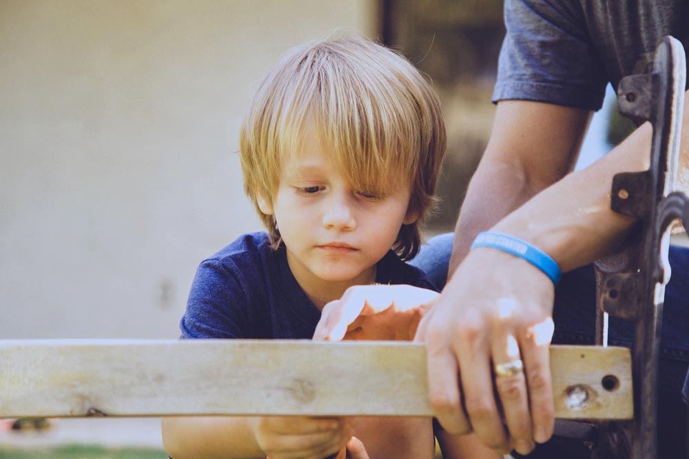 keep a good handyman around by investing in his health and acknowledging the additional work he puts n on your home with a helper to hold the screw gun during custom wood assembly father and son team in olive branch ms