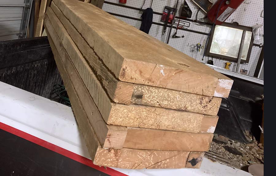 stack of five custom made floating shelf slabs on the back bed of a pickup truck at 1 Handy Craftsman shop in Olive Branch, MS during home improvement project for local interior design team