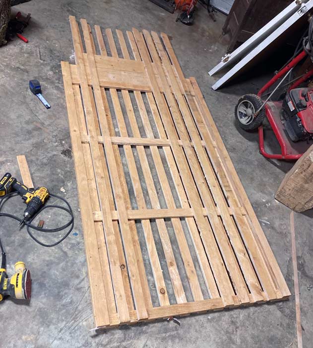 2 inch cut red cedar picket wood laying on shop floor in Olive Branch Mississippi for backyard brick wall gate custom framed by local quality framing carpenter