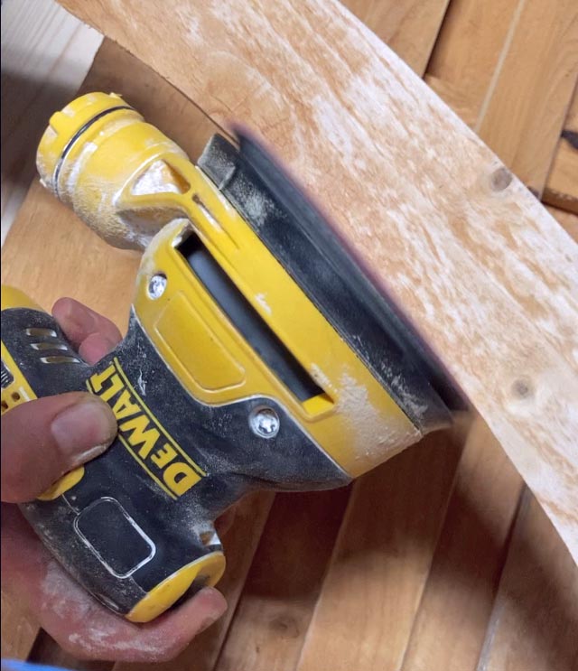 carpenter showing how to create wooden arch for cedar gate sanding edges to prime for paint near Memphis TN