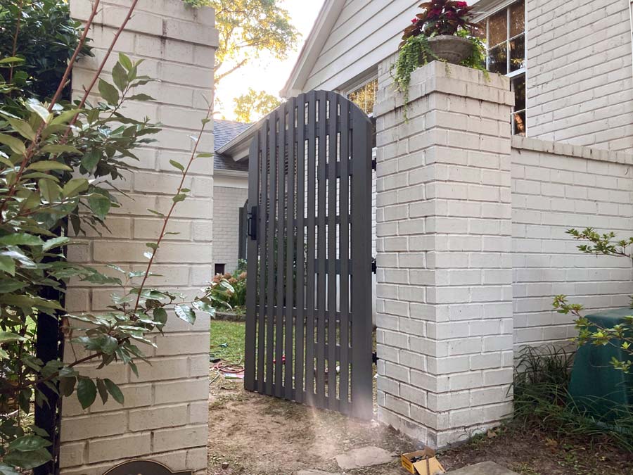 welcome to my backyard gate with hand crafted arch on beautiful white brick walls for garden entrance carpentry by 1 Handy Craftsman uptown memphis tn district